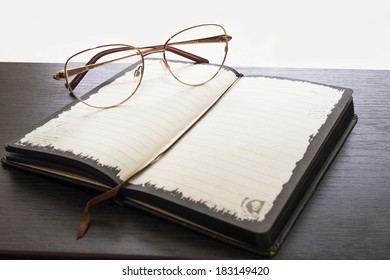 glasses and notebook on a table