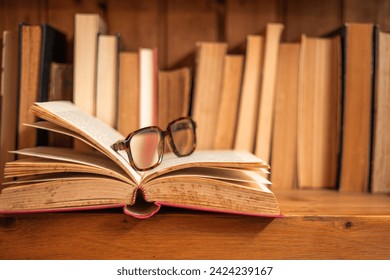 glasses on open book in a bookcase of a bookstore world book day - Powered by Shutterstock