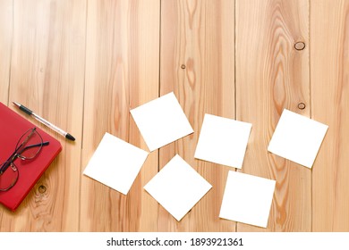glasses are on the table on an open notebook. business concept. small pieces of paper are scattered on the table