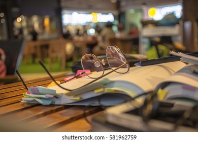Glasses with an open book in a cafe.