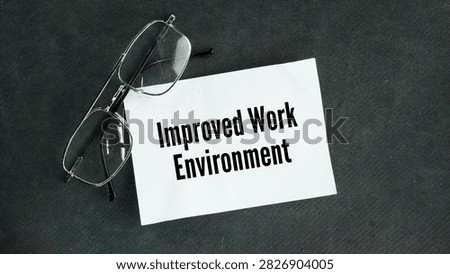 Glasses and paper with the words Improved work environment. a safer, more supportive, and better-organized workplace that boosts employee happiness, health, and productivity.