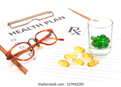  Glasses And Pill Capsules Resting On Health Plan Notes Or Patient Record Form