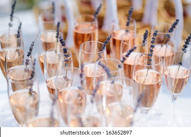 Glasses of with pink champagne decorated with lavender