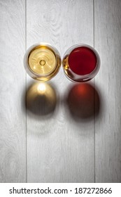 Glasses Of Red And White Wine On Wooden Table. Top View