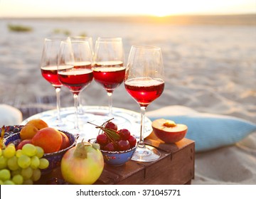 Glasses Of The Red Wine On The Sunset Beach Picnic