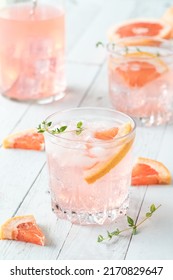 Glasses Of Refreshing Grapefruit Spritzer On A Light Wooden Table. 