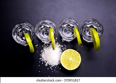 Glasses Of Silver And Gold Tequila With Lime In A Bar