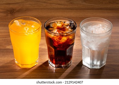 Glasses of soda flavors orange, lemon and coke. - Shutterstock ID 2129142407