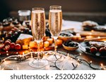 Glasses of sparkling wine or champagne served on the table for Christmas or New Year eve celebration.