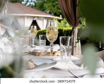 Glasses Of Sparkling Wine On The Table In An Outdoor Restaurant.