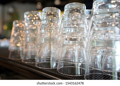 Glasses Are Standing Upside Down During Golden Hour. Glass Empty In Cafe.