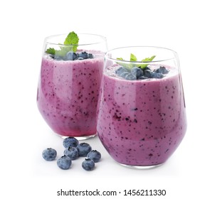 Glasses Of Tasty Blueberry Smoothie With Mint On White Background