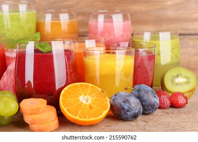 Glasses of tasty fresh juice, on wooden table. - Powered by Shutterstock