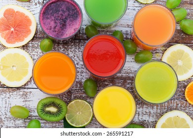 Glasses Of Tasty Fresh Juice, On Wooden Desk. Unusual Top View