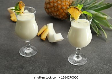Glasses of tasty Pina Colada cocktail on table