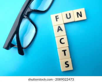 Glasses and toys word with text FUN FACTS on a blue background. - Shutterstock ID 2089022473