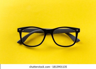 Glasses For Vision In Black Frames On A Yellow Background. Short Sighted And Presbyopia (Farsightedness) Eyeglasses.