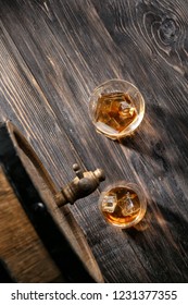 Glasses Of Whiskey Near Barrel On Wooden Table, Top View