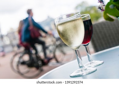 Glasses Of White And Red Wine On A Table Outside A Bar In Amsterdam