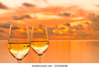 Glasses Of White Wine Against Sunset 