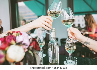 Glasses With White Wine In Hands Making A Toast, Concept Of Party