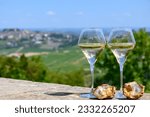 Glasses of white wine from vineyards of Sancerre  Chavignol appelation and example of flint pebbles soil, near Sancerre village, Cher, Loire valley, France.