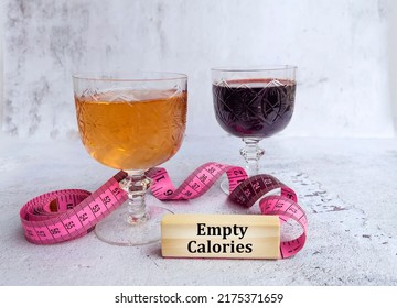 Glasses Of Wine And Rose With  Measuring Tape And Empty Calories  Text On Wooden Cubes 