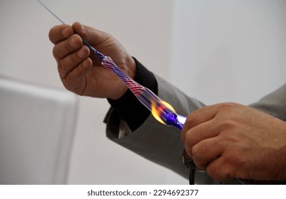 A Glassmaker Making Glass with Fire - Powered by Shutterstock