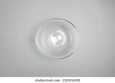 Glassware. Crystal transparent utensils. Fruit bowl. vase, glass plate for dessert, serving tea  isolated on gray background.High resolution photo.Top view. Mock-up.