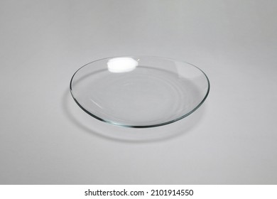 Glassware. Crystal transparent utensils. Fruit bowl. vase, glass plate for dessert, serving tea  isolated on gray background.High resolution photo.Top view. Mock-up.