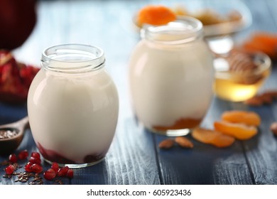 Glassware with delicious yogurt on wooden table - Powered by Shutterstock