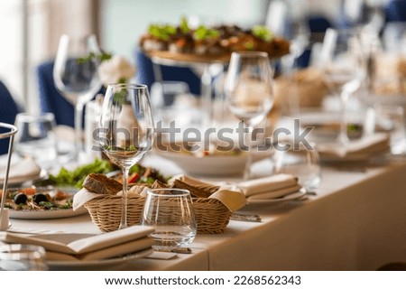 Glassware on a served table in a restaurant lined up perspective