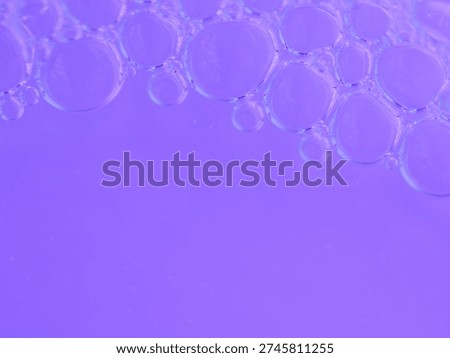Glassy bubbles float softly on vivid purple water