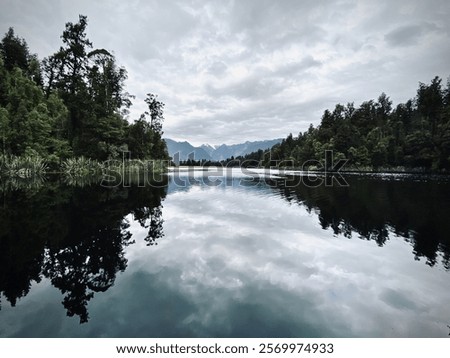 A glassy lake in Sweden, the sky reflected in the water