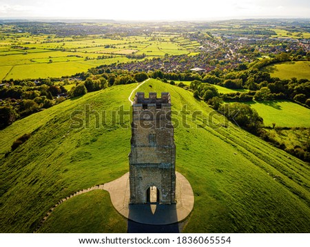Glastonbury Tor near Glastonbury in the English county of Somerset, topped by the roofless St Michael's Tower, UK