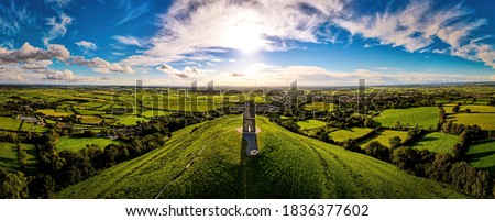Glastonbury Tor near Glastonbury in the English county of Somerset, topped by the roofless St Michael's Tower, UK