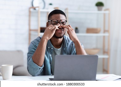 Glaucoma. African American Man Massaging Tired Eyes Suffering From Eyestrain And Fatigue, Exhausted After Work On Computer Sitting At Workplace In Office. Eye Sight Problem Concept - Shutterstock ID 1880300533