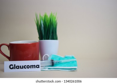 Glaucoma Text, Grass Pot, Coffee Cup, Syringe, And Face Green Mask. Healtcare/Medical And Business Concept