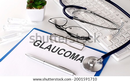 GLAUCOMA text on white paper on the white background. stethoscope ,glasses and keyboard