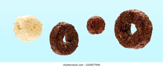 Glazed, chocolate, corn rings and balls for cereals dry breakfast on blue background 