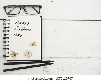 Glazed cookies and sketchbook with handwritten congratulation on Father's day on a beautiful, white table. Top view. Happy family concept - Powered by Shutterstock