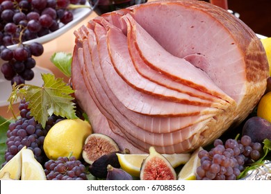 Glazed Delicious Whole Baked Honey Sliced Ham With Figs, Lemons And Champagne Grapes.