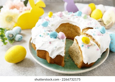 Glazed easter lemon cake decorated with confectionery and mini chocolate eggs candy on gray stone background. Happy Easter holidays, tasty dessert. - Powered by Shutterstock