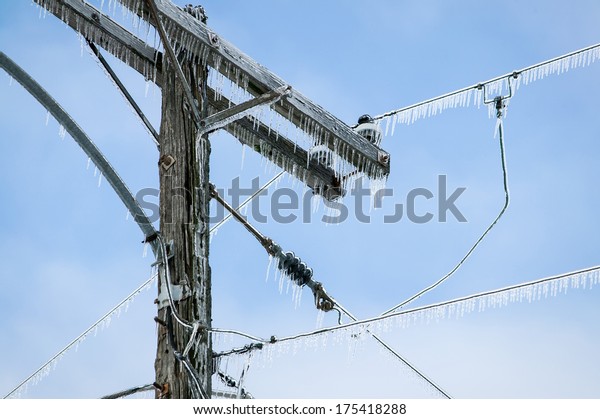 Glazed Power Line Utility Pole Electric Line from\
Winter Ice Snow Storm,\
Icicles