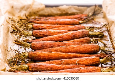 Glazed And Roasted Young Red Carrots On A Piece Of Baking Paper,  Baked  Baby Carrots In  Horizontal Overhead View. Thyme, Maple Syrop, Balsamic