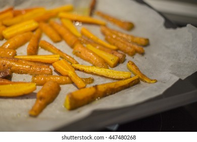 Glazed And Roasted Young Red Carrots On A Piece Of Baking Paper, Baked Baby Carrots In Horizontal Overhead View. Thyme, Maple Syrop, Balsamic