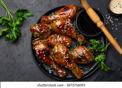 Glazed Teriyaki Chicken Legs On Black Plate, Top View