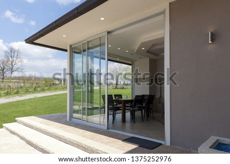 glazed terrace in the countryside with sliding glass