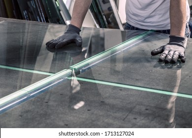 glazier breaking glass on a professional table - Shutterstock ID 1713127024
