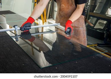 The Glazier Cuts A Large Sheet Of Glass. Glass Workshop, Specialist Work Tools 